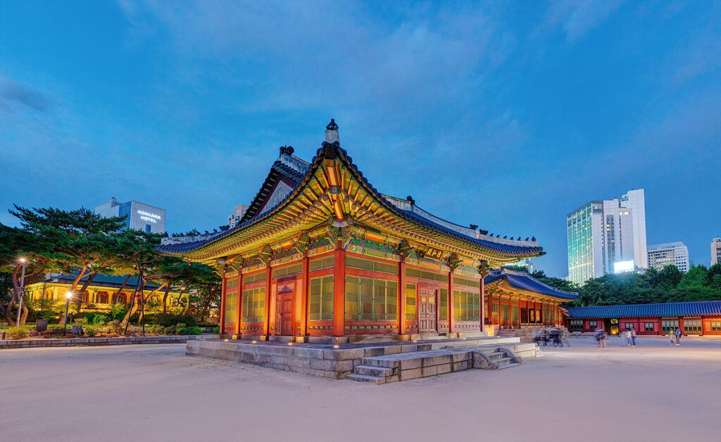 Deokhongjeon Hall at Deoksugung Palace, beautifully illuminated at night.
